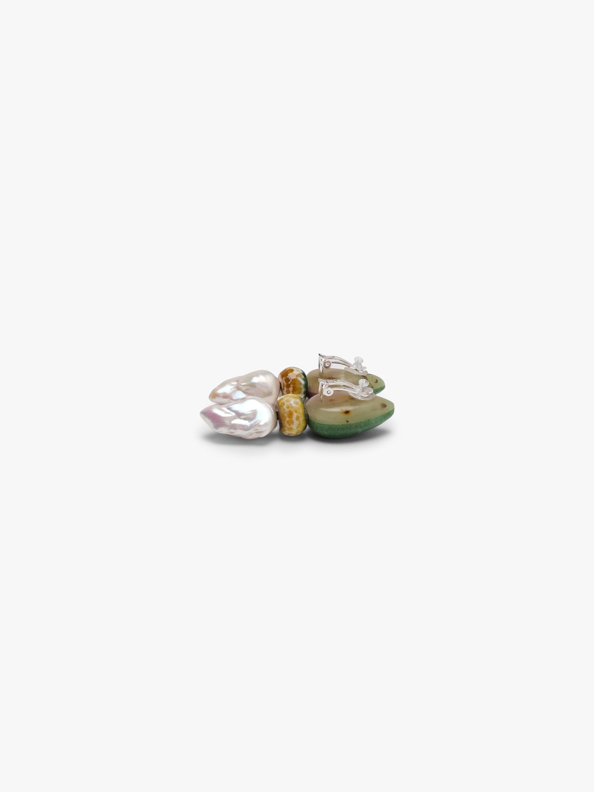 Earrings with a green and purple top paired with a small yellow stone and baroque pearls. Displayed on a white background. 