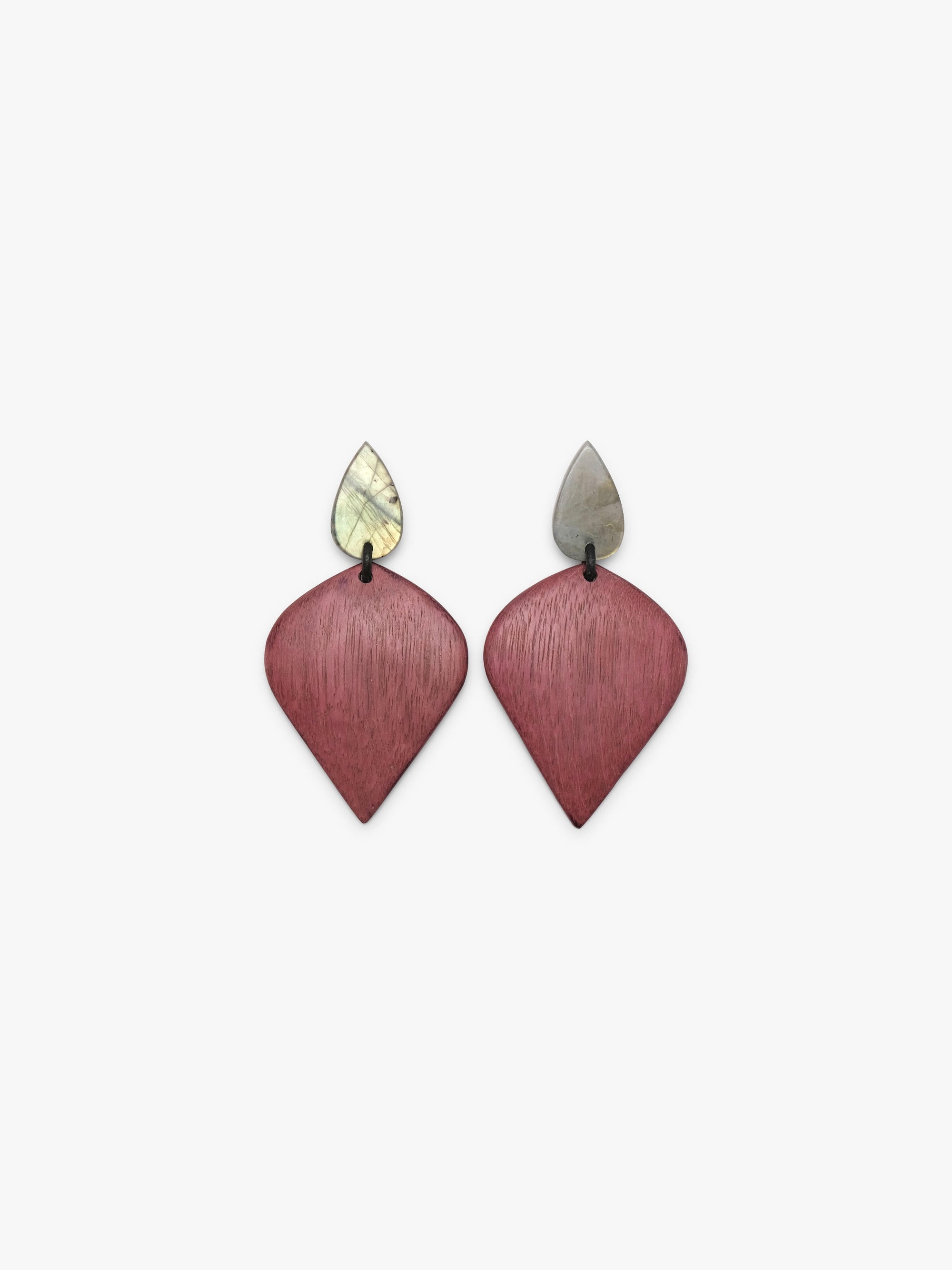 A pair of geometric drop earrings featuring textured, brushed rose-pink teardrop-shaped pendants with small, pointed silver-toned studs on a light gray background.