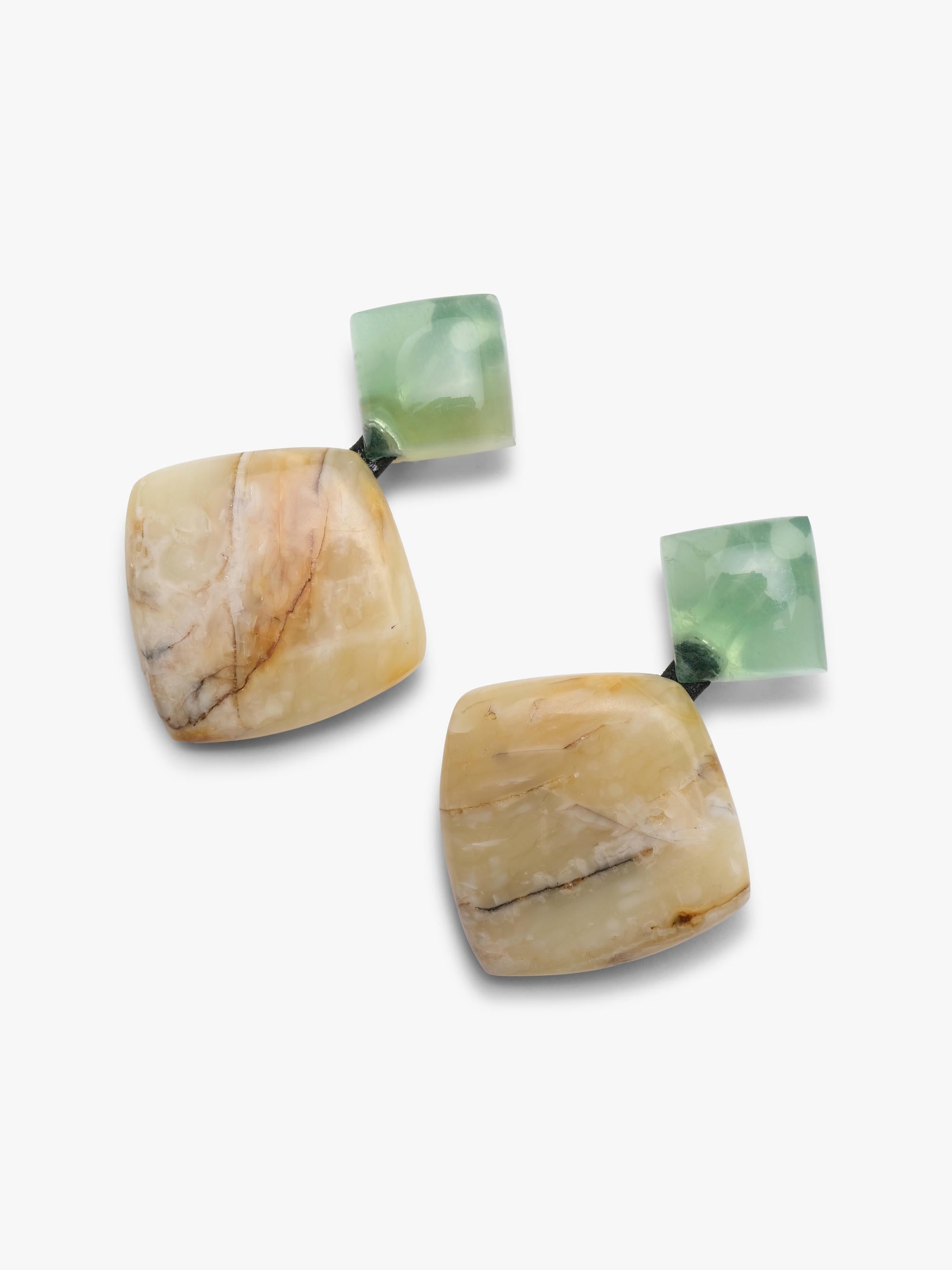 A pair of handmade dangle earrings featuring light green faceted gemstone studs and irregular, organic-shaped beige and brown stone drops, displayed on a clean white background.