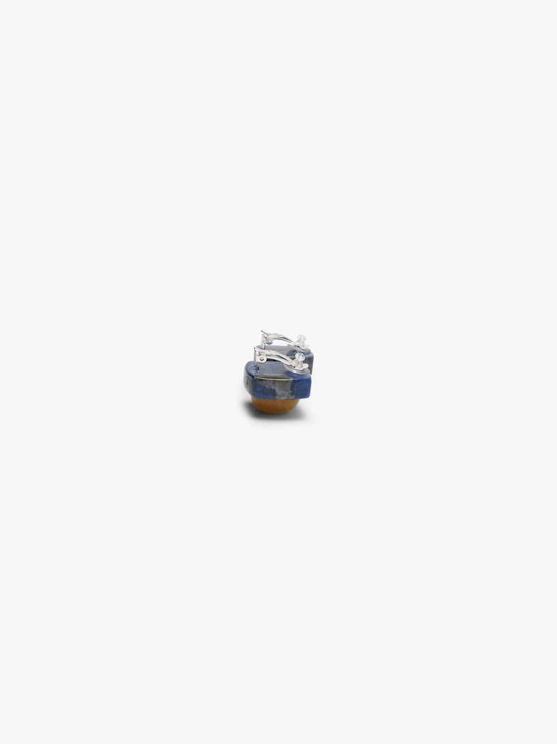 Earrings featuring rounded domeshaped yellow brownish stone set into a deep blue stone. Displayed on a white background. 