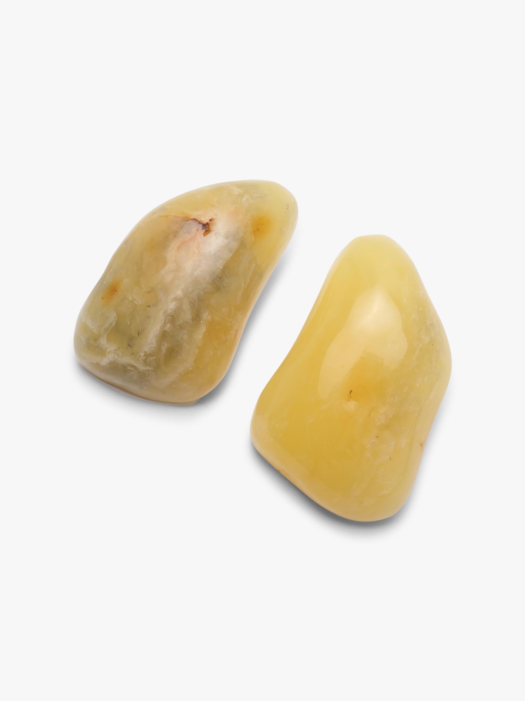 A pair of irregular yellow amber earrings displayed on a white background