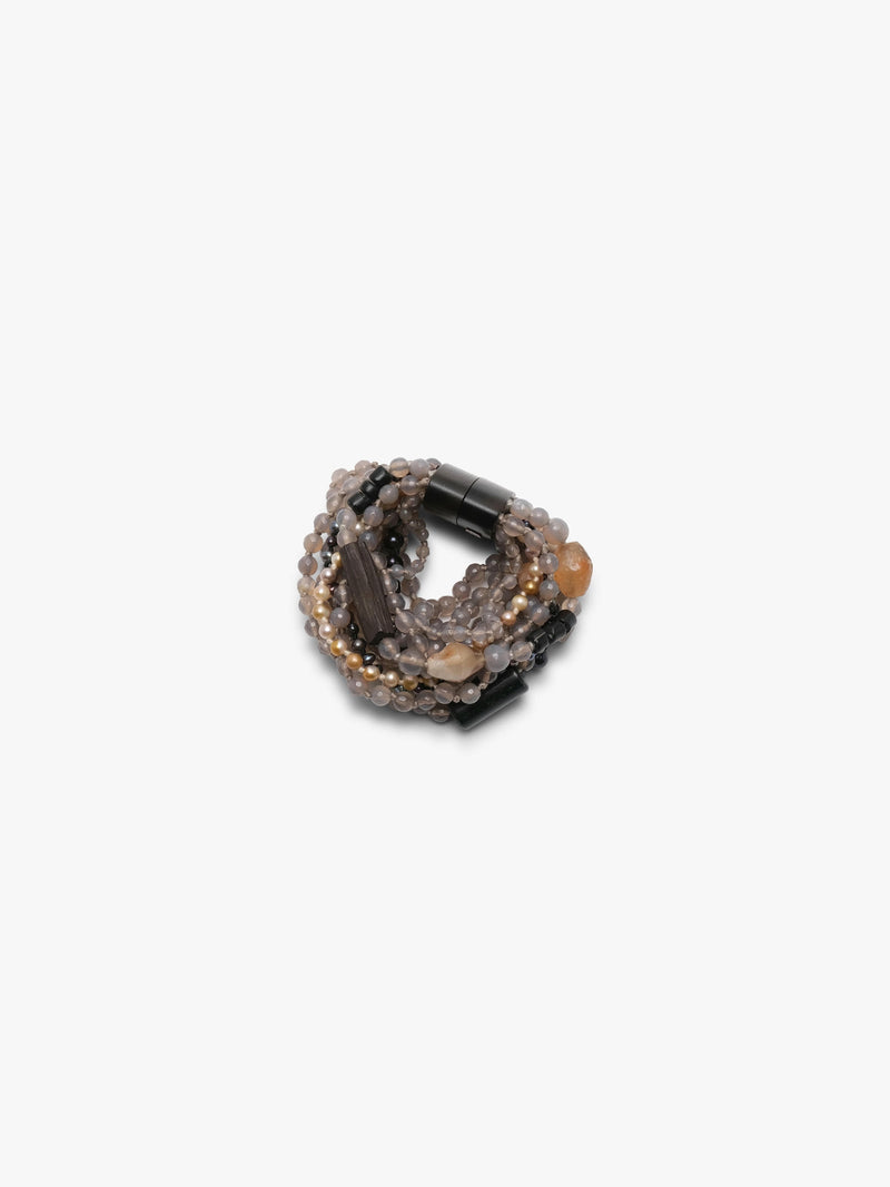 Multistrand bracelet in grey, beige and orange colours. Placed on a white background.