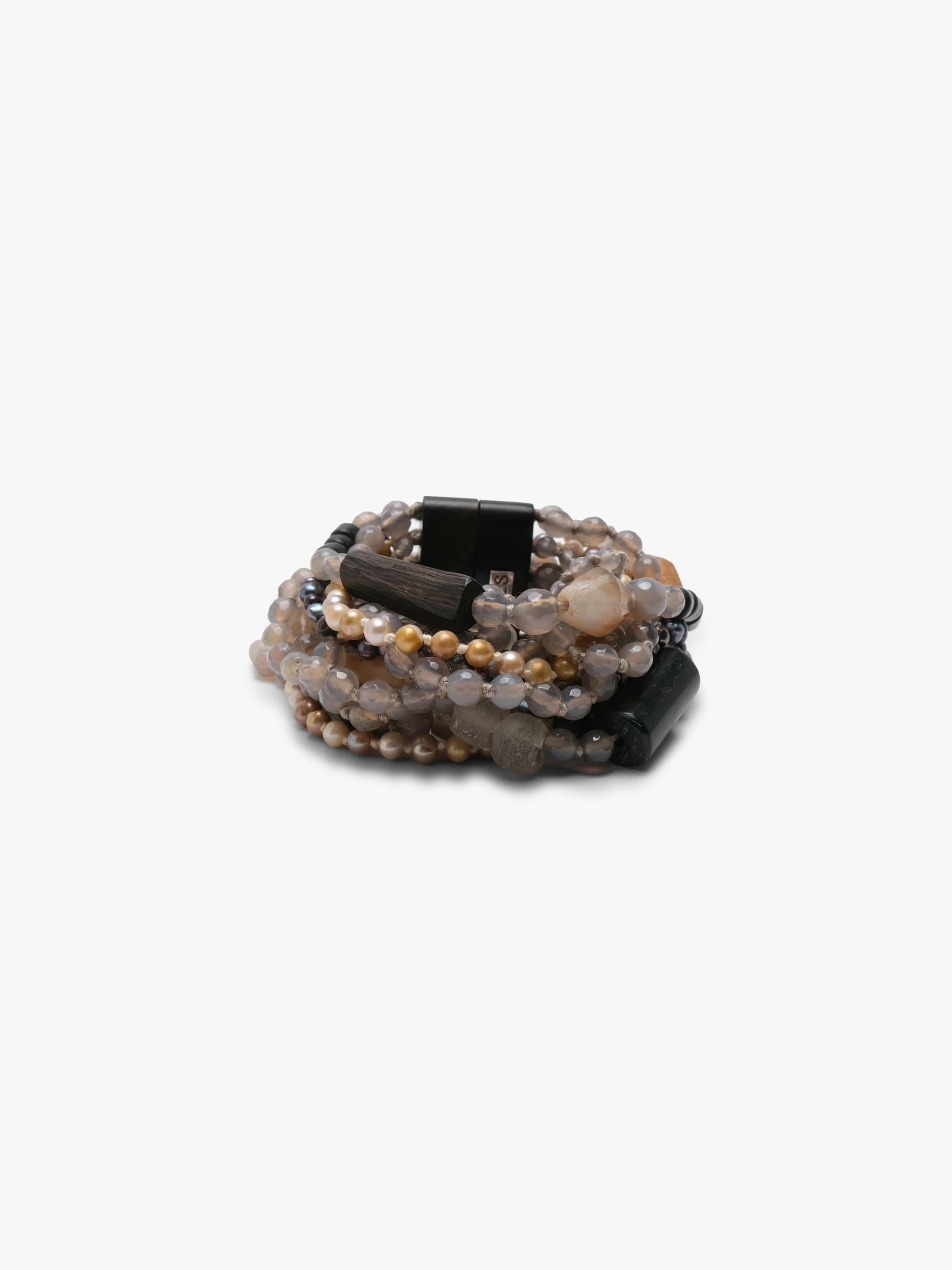 Multistrand bracelet in grey, beige and orange colours. Placed on a white background.