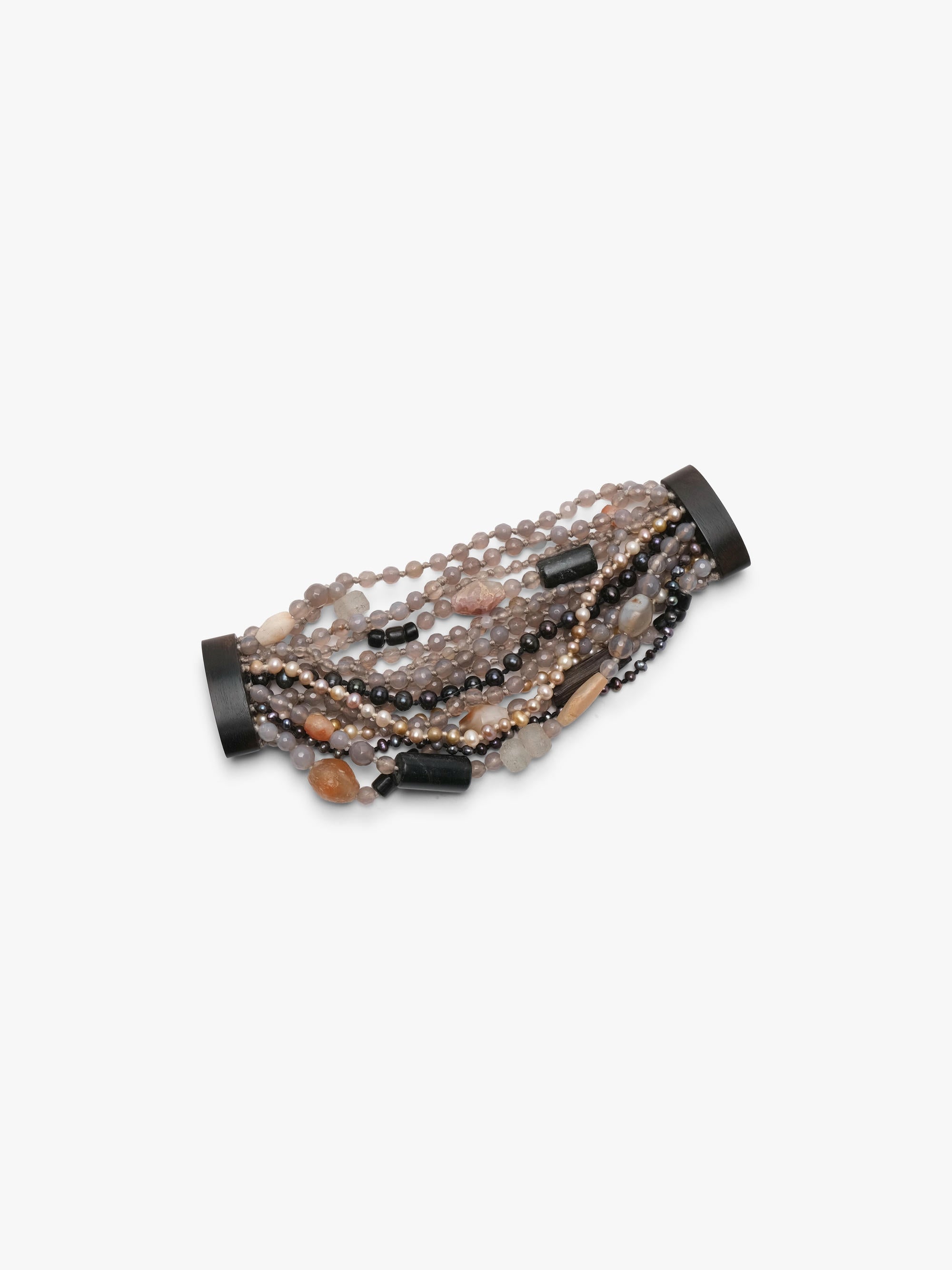 Multistrand bracelet in grey, beige and orange colours. Placed on a white background.