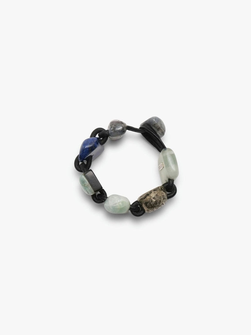 Bracelet in different stones and leather on a white background