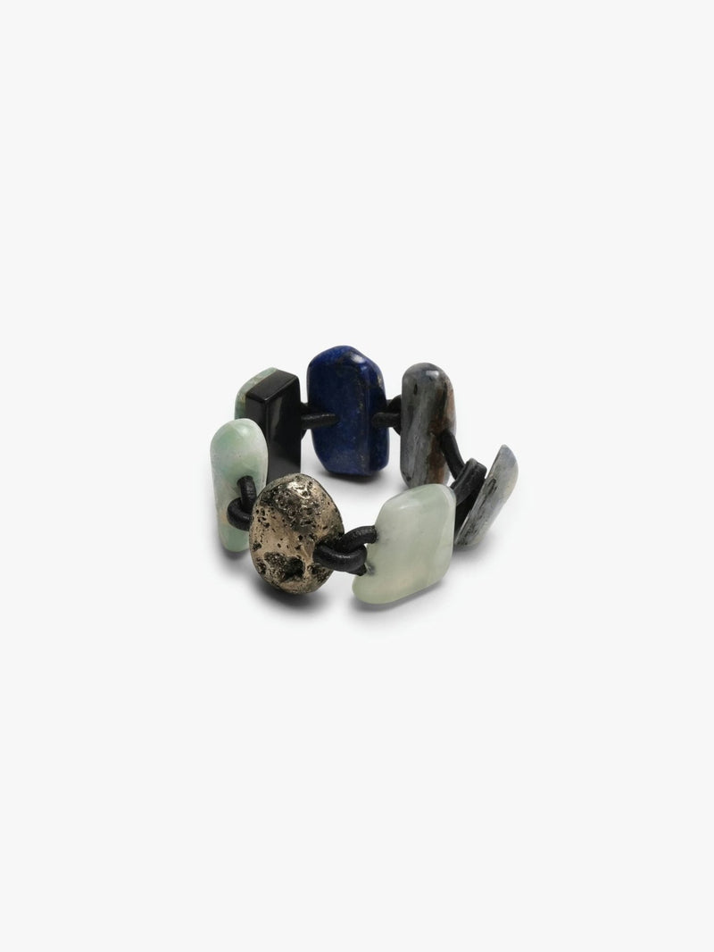 Bracelet in different stones and leather on a white background