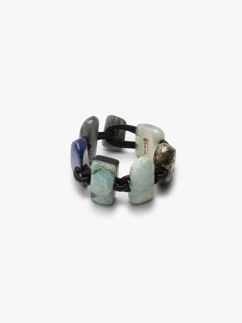 Bracelet in different stones and leather on a white background