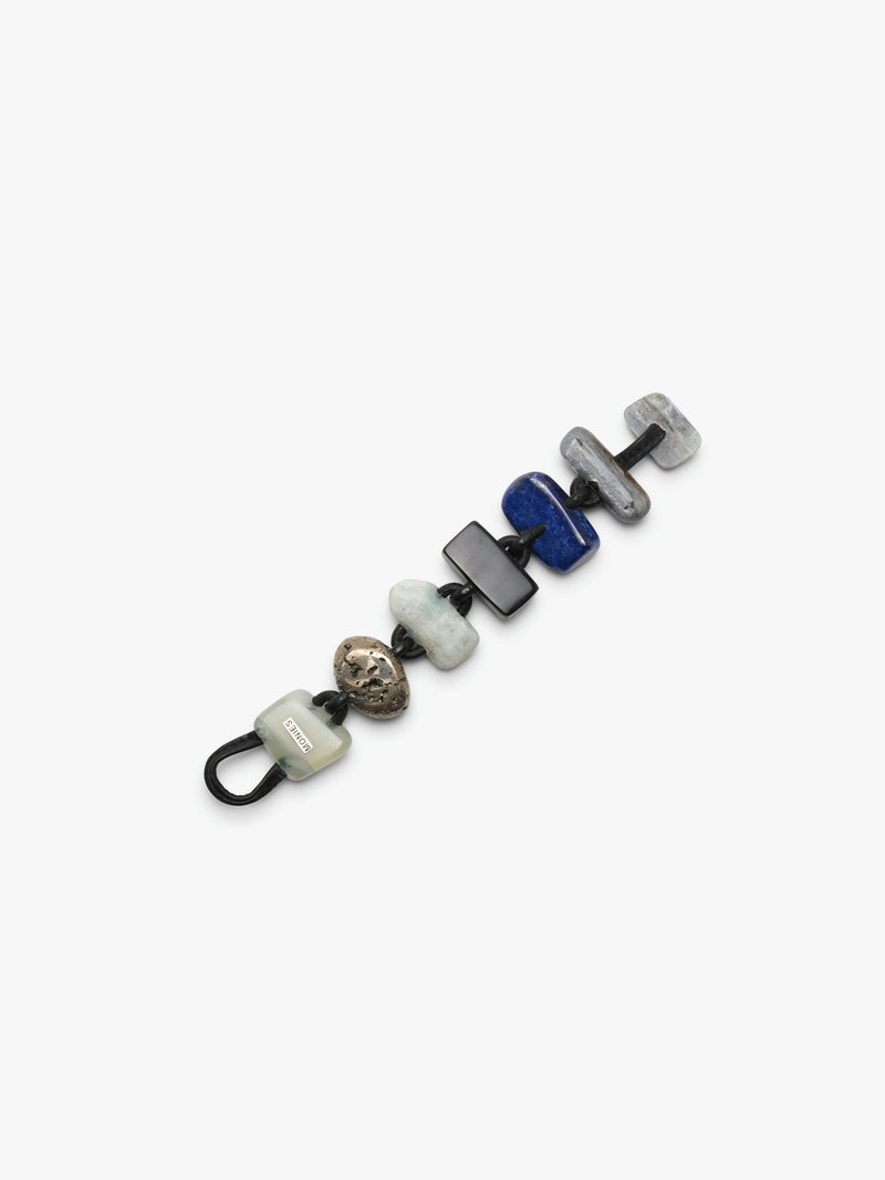 Bracelet in different stones and leather on a white background