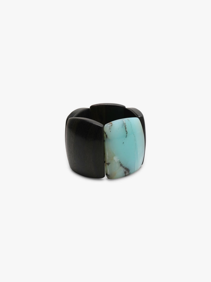 A bracelet made from black and light blue stone squares, displayed on a white background