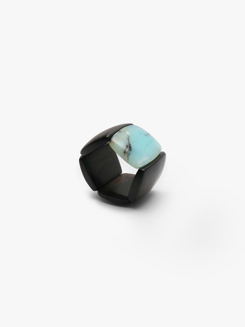 A bracelet made from black and light blue stone squares, displayed on a white background