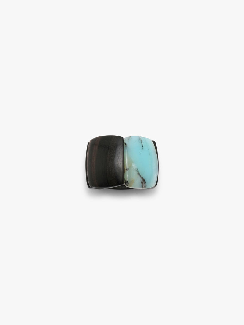 A bracelet made from black and light blue stone squares, displayed on a white background