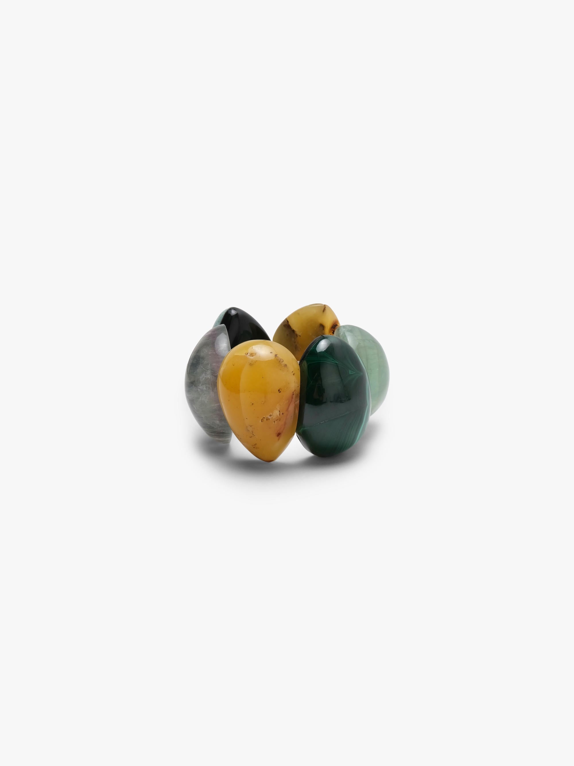 A bracelet of five polished teardrop-shaped gemstone pendants in various colors including yellow, green, gray, and black, arranged on a plain light gray background.