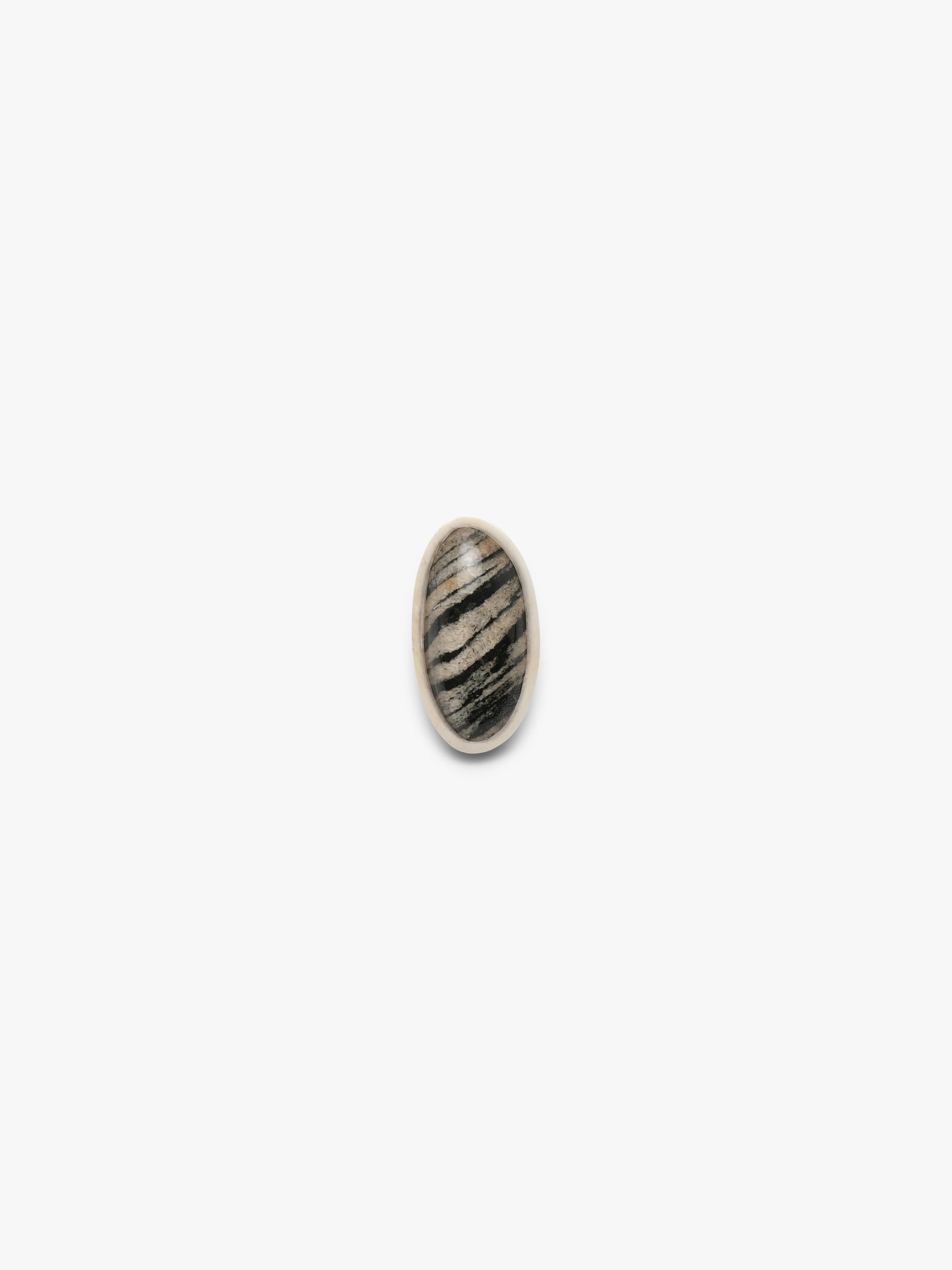 Small oval stone made of born, hornblende and quartz