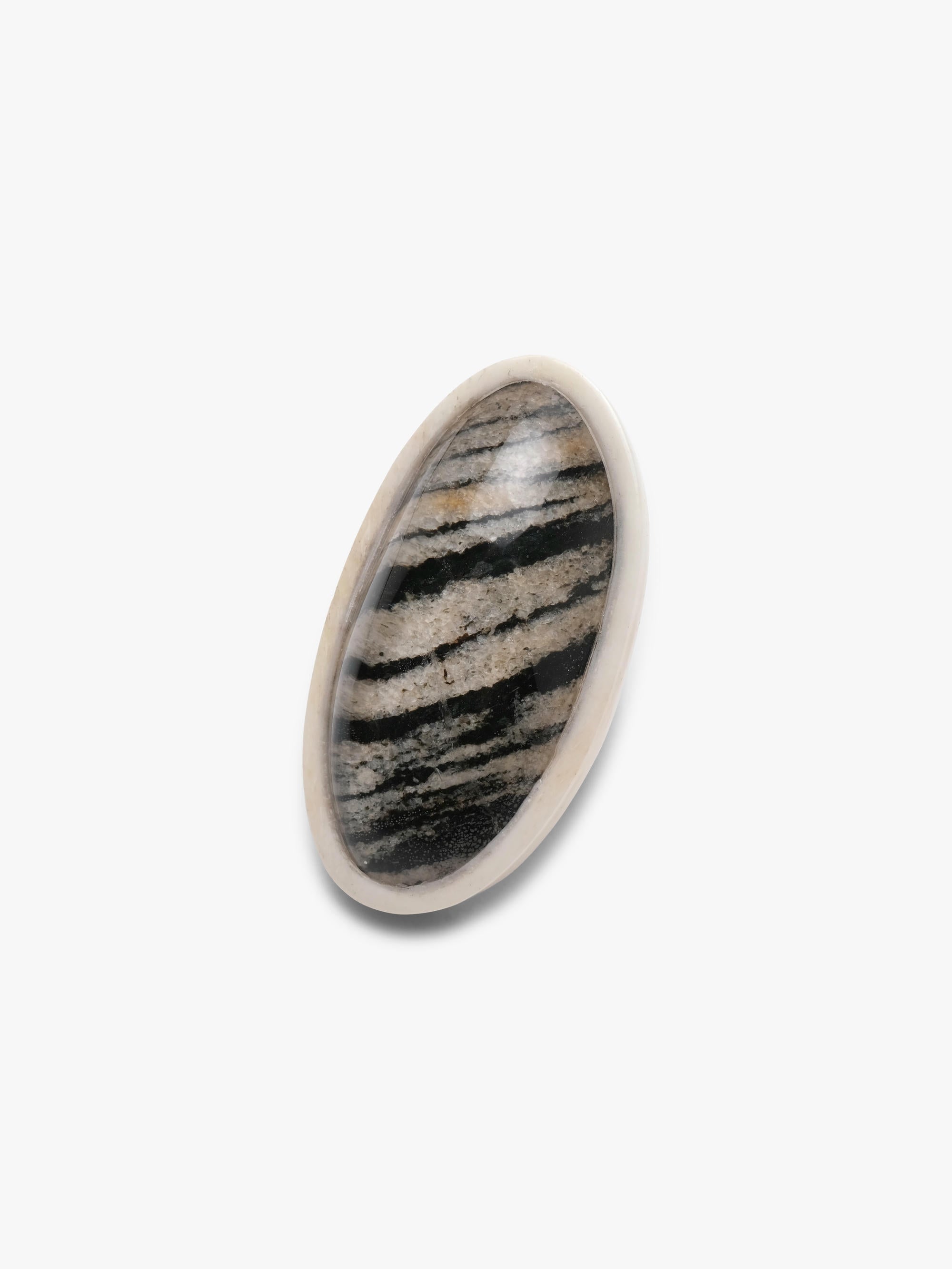 Small oval stone made of born, hornblende and quartz