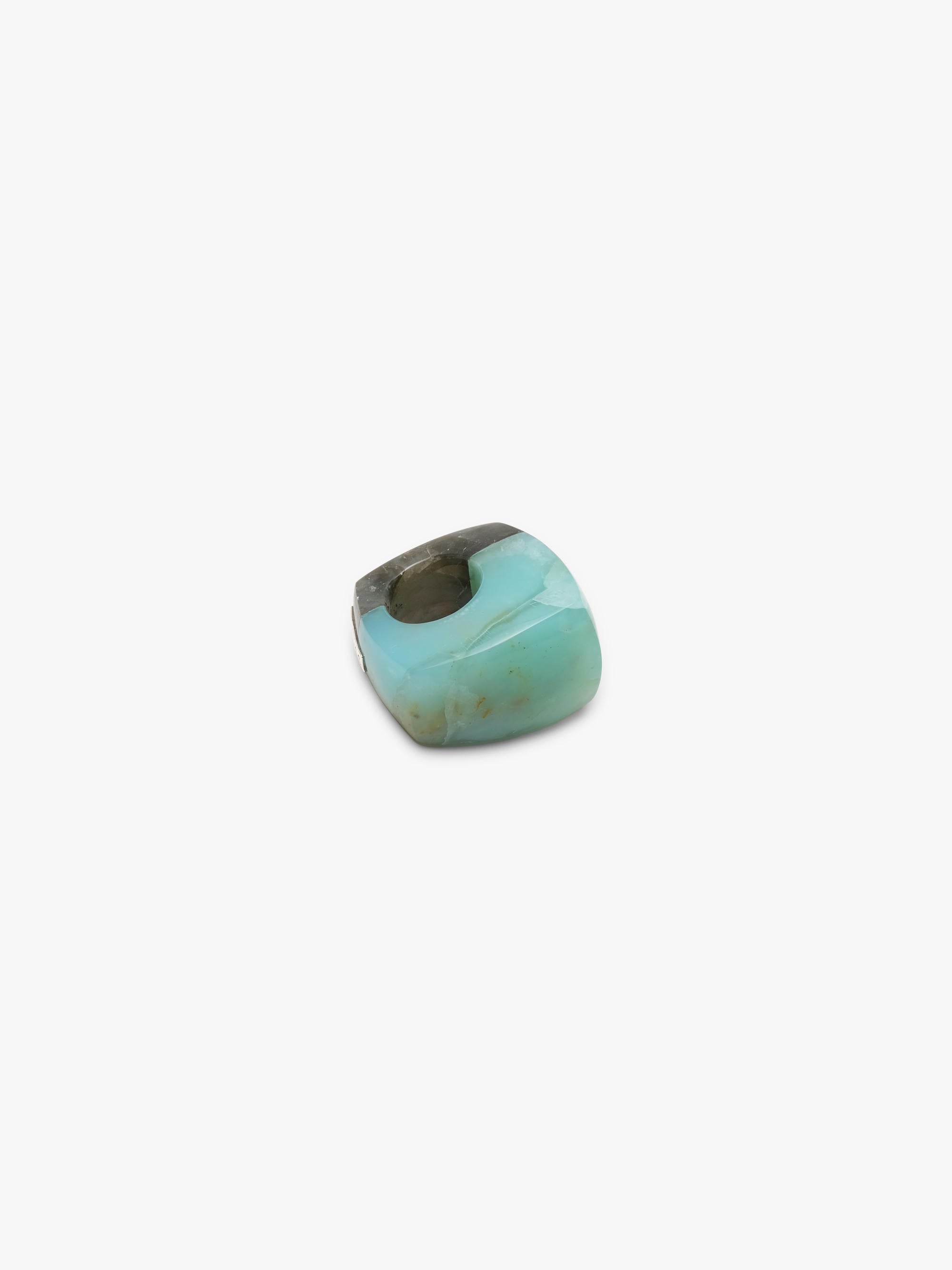 A single polished cabochon ring with a marbled pattern of light turquoise, olive green, and dark brown, shown on a plain light gray background.