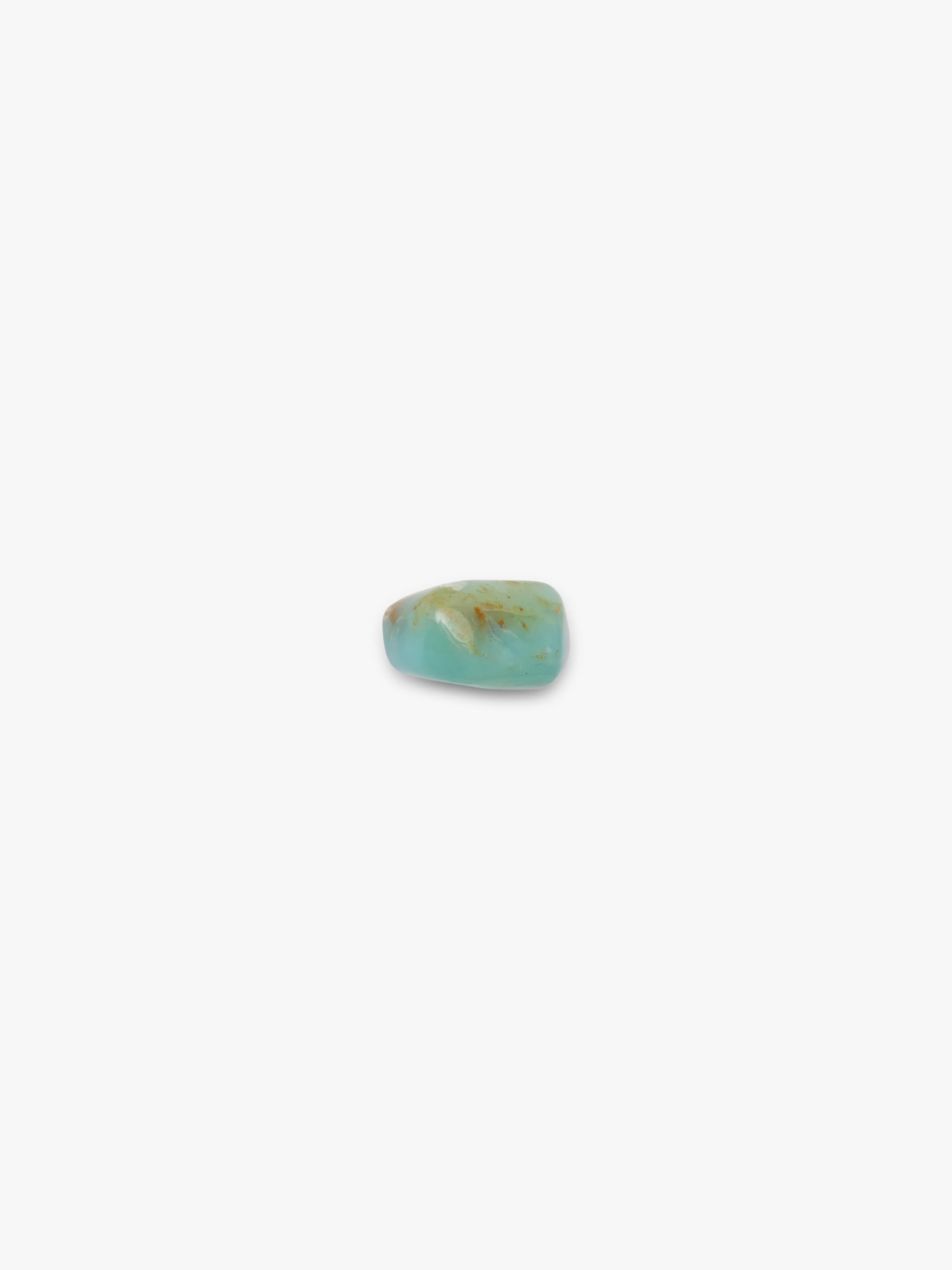 A small, polished turquoise-colored stone bead with natural brown matrix inclusions, centered on a plain white background.