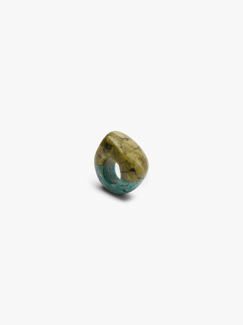 A small polished olive green ring cabochon with natural marbling, centered on a plain white background.