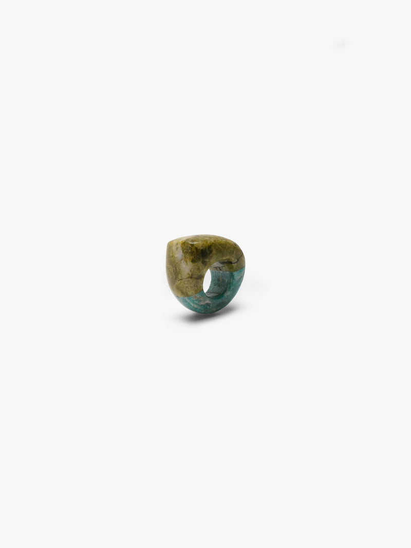 A small polished olive green ring cabochon with natural marbling, centered on a plain white background.