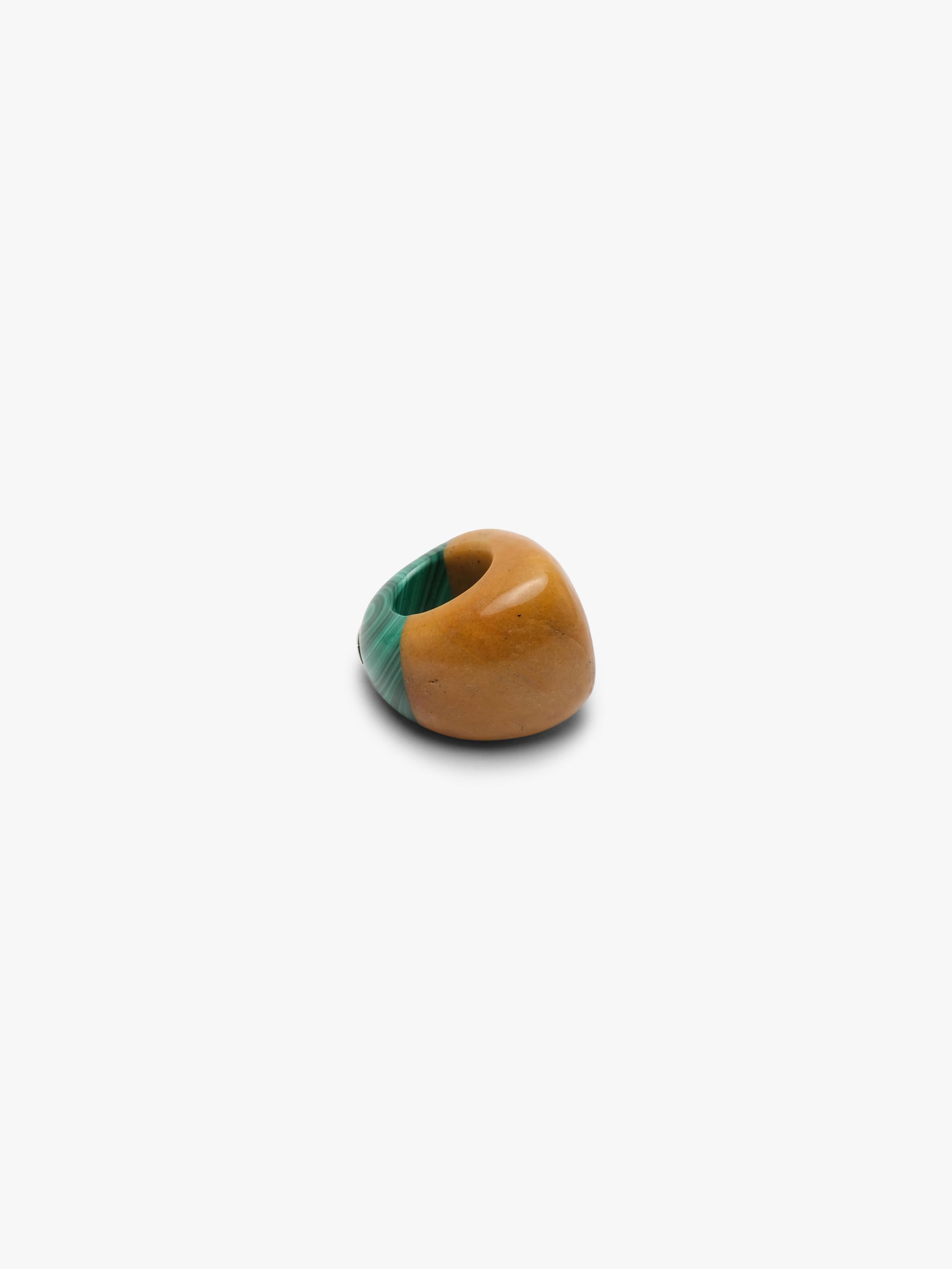 Ring made of two combined stones in a warm orange and green color, displayed on a white background