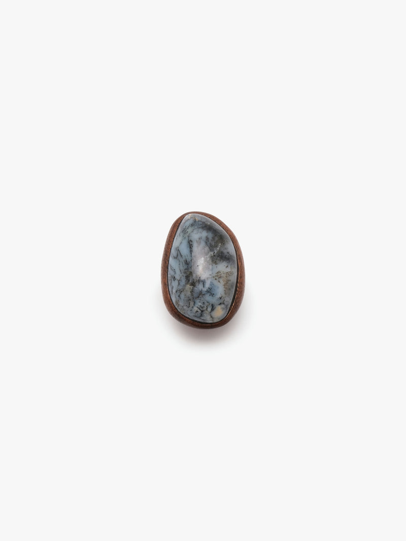 A dendritic, mahogany ring displayed against a white background