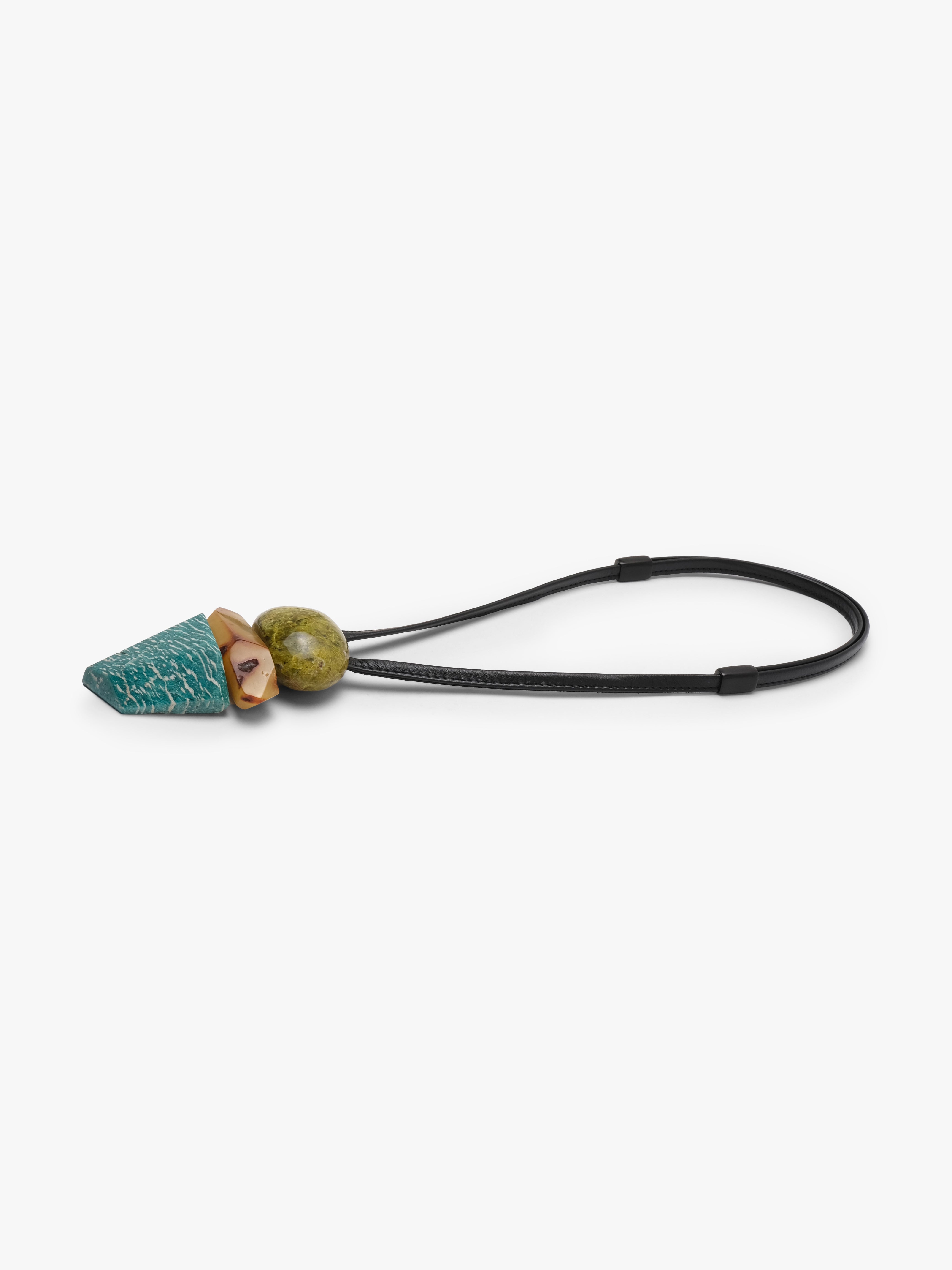 Leather cord pendant with a stone cluster of stones in greed, orange and blue with white stripes. Displayed on a white background