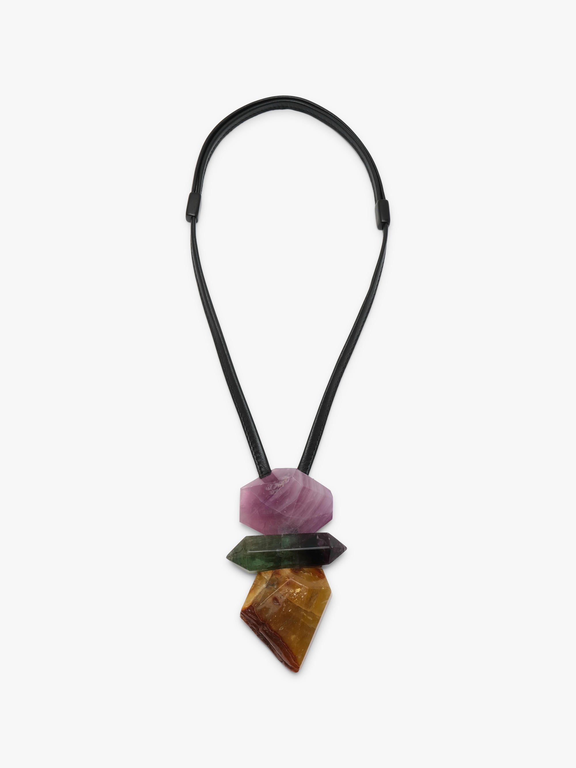 A multi-stone necklace pendant featuring a black elastic cord and three stacked, tapered crystal points in pink, green, and brown, displayed against a light gray background.
