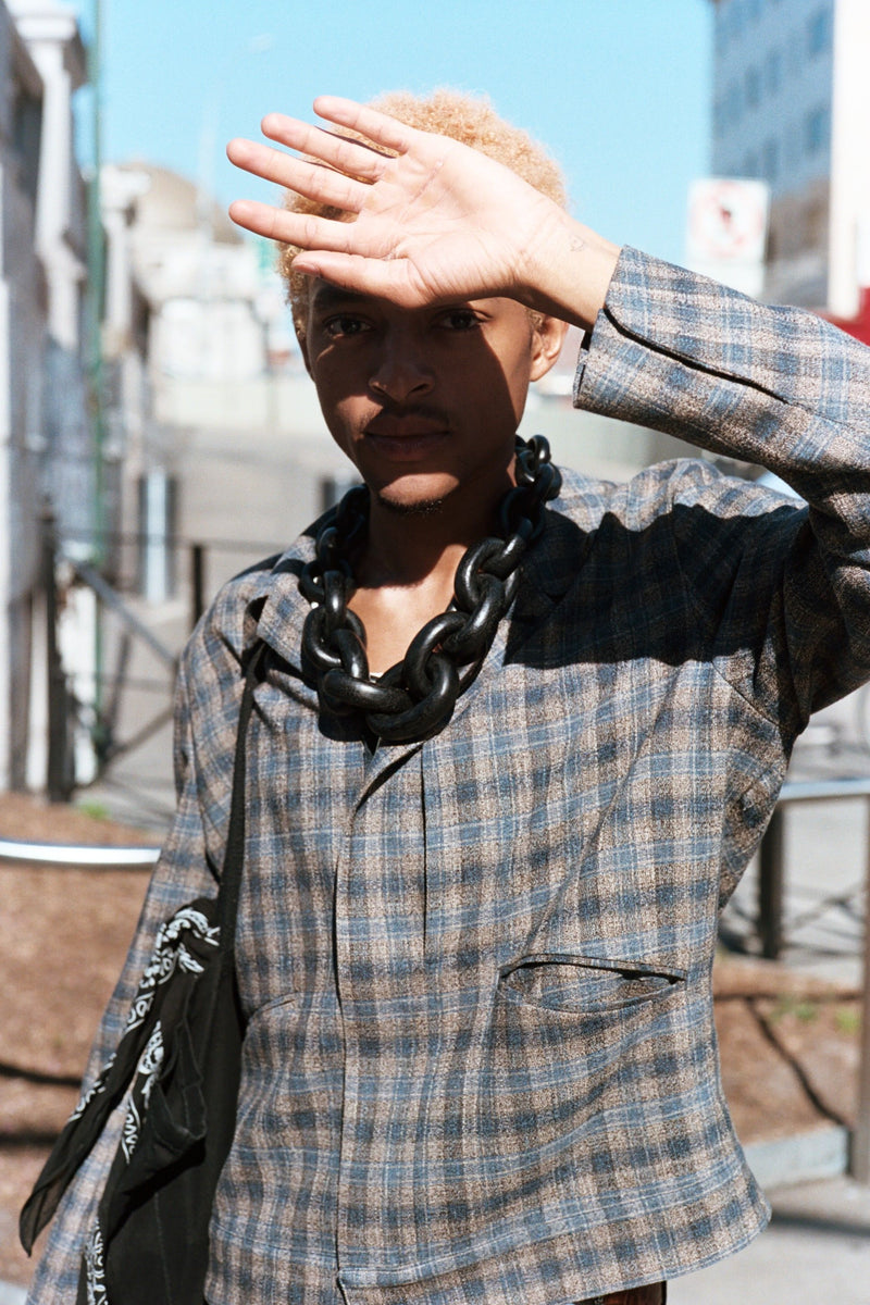 a person wearing a black chain necklace