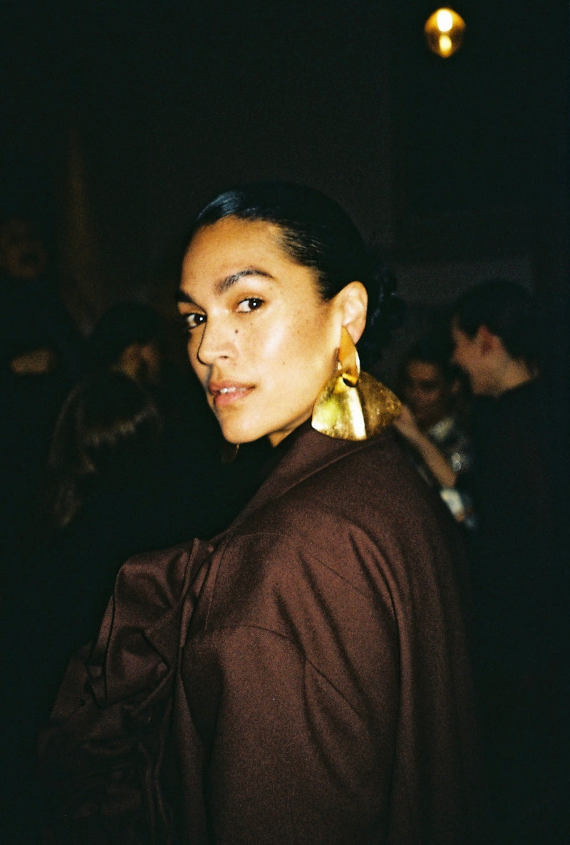 Woman wearing large gold earrings