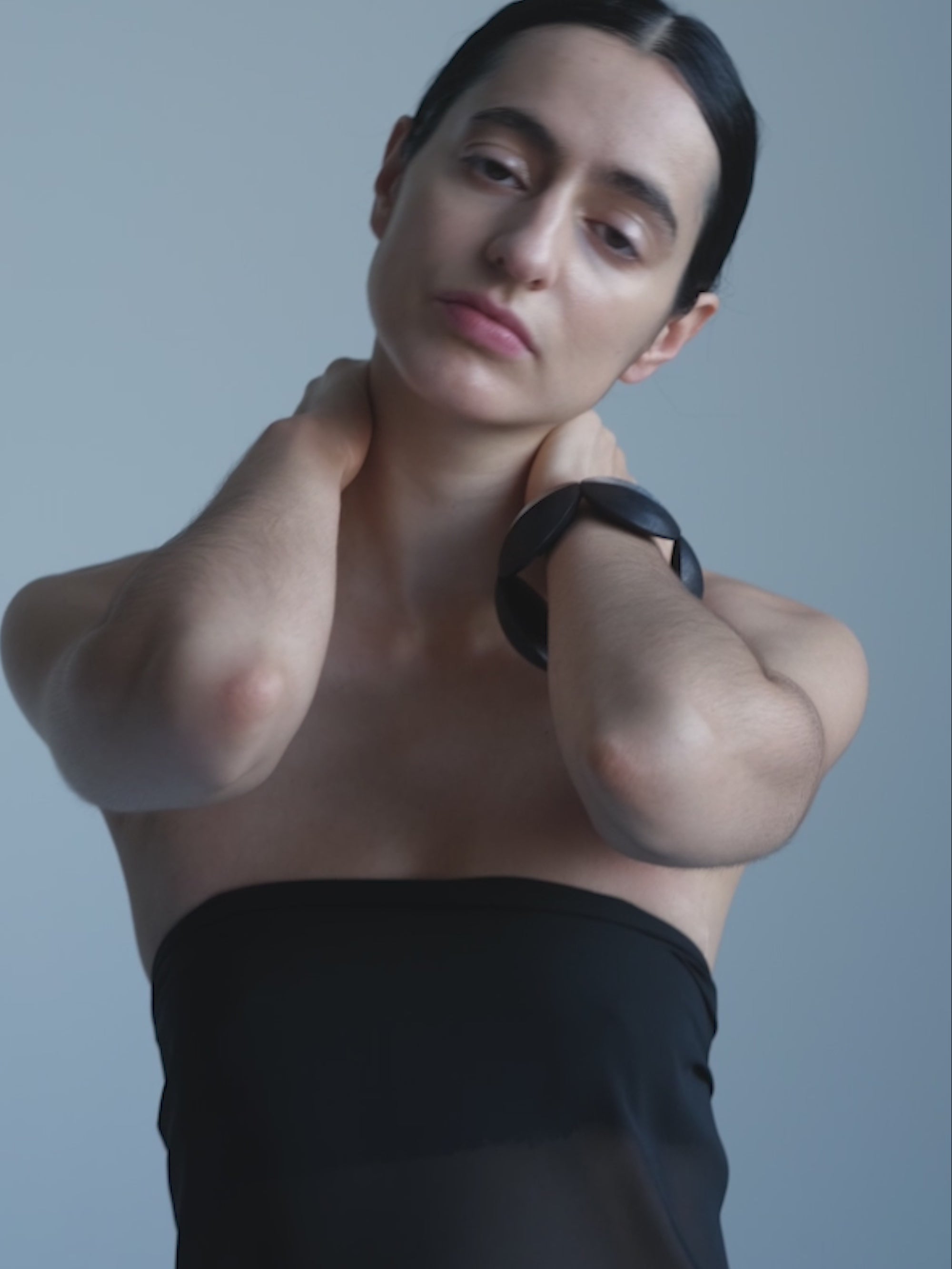 Woman wearing a Black and silver bracelet on a white background