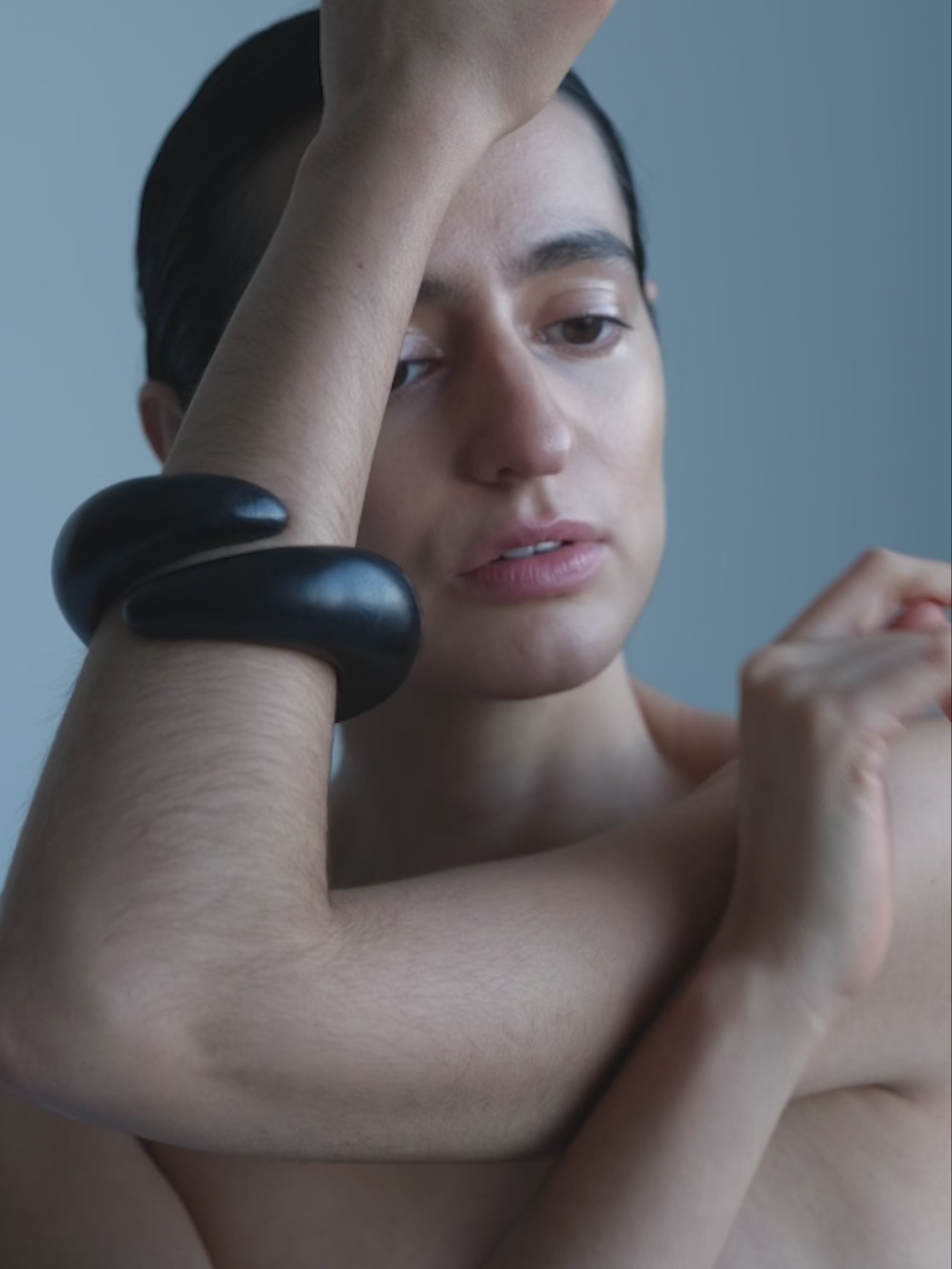 Woman wearing a Black wooden bracelet on a white background