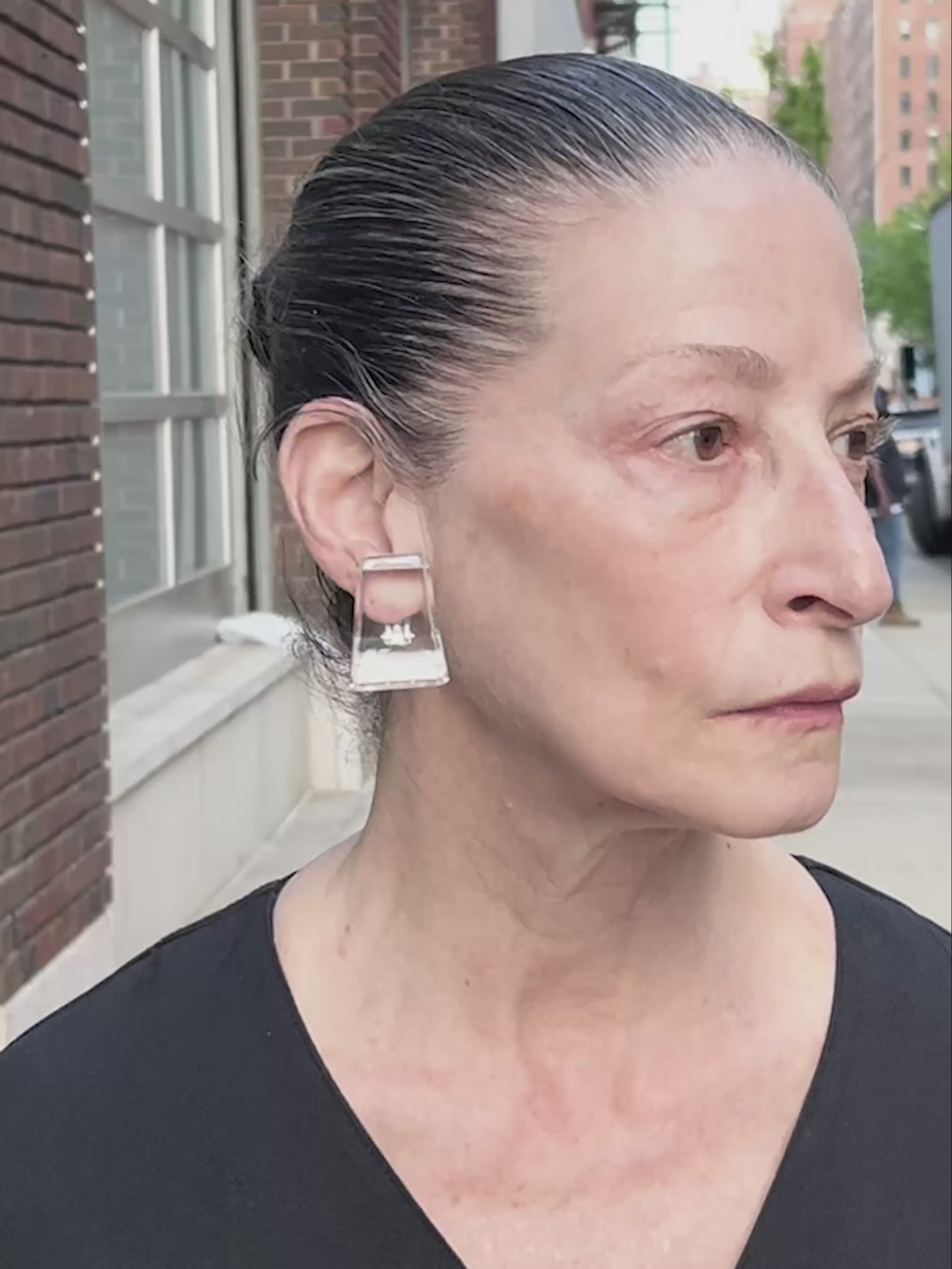 Woman wearing transparent earrings while walking around in new york