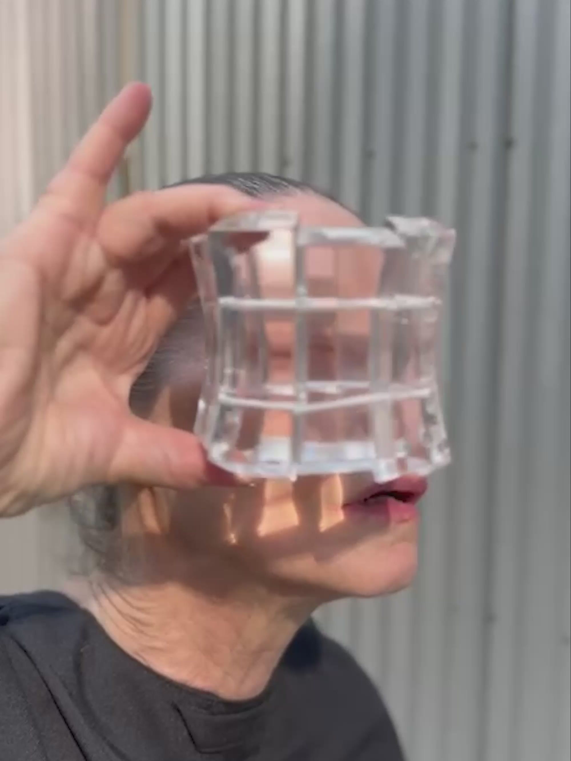woman holding a transparent bracelet in front of her eyes