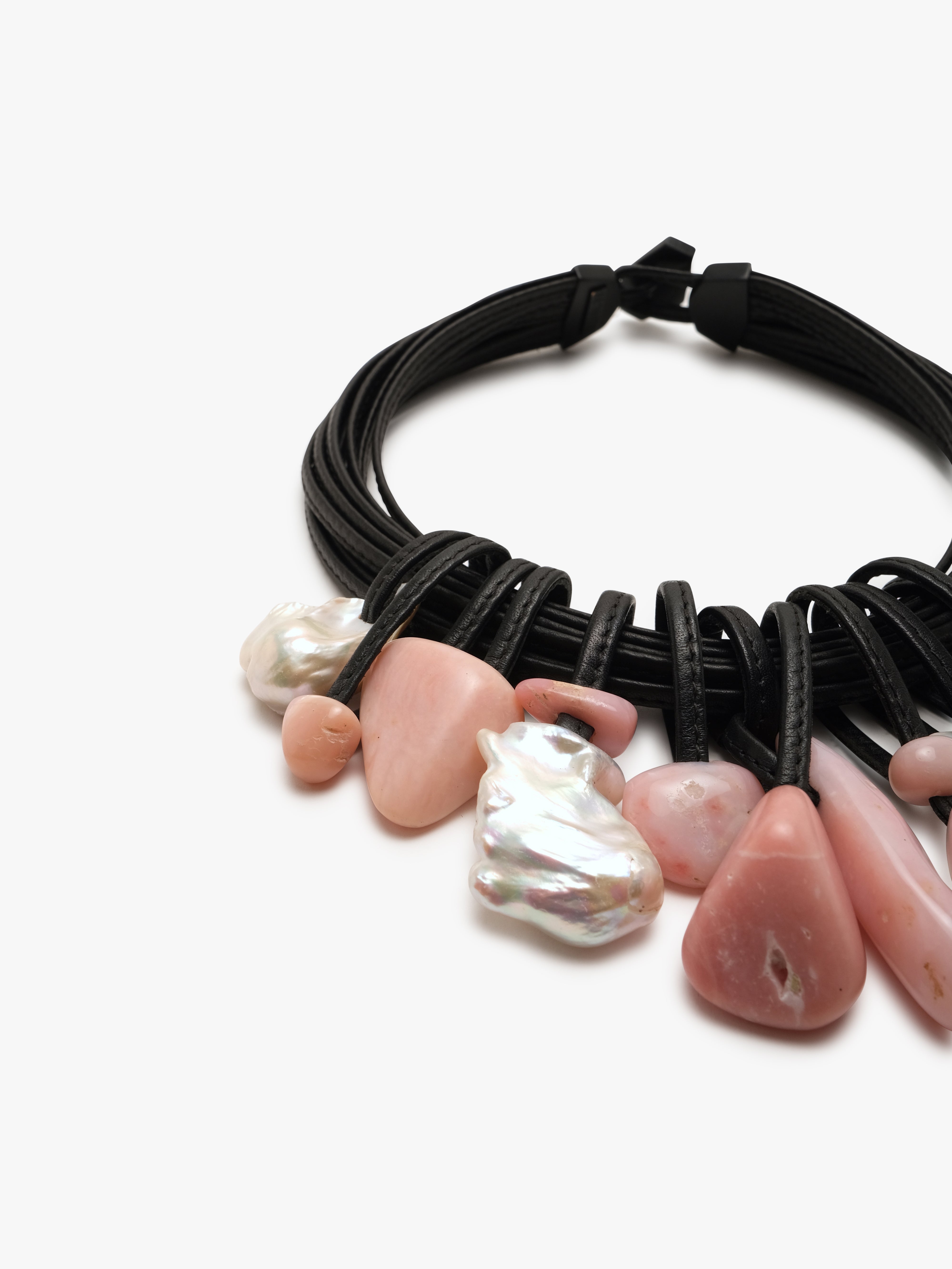 A black leather necklace with freshwater pearls and Andean opal accents.