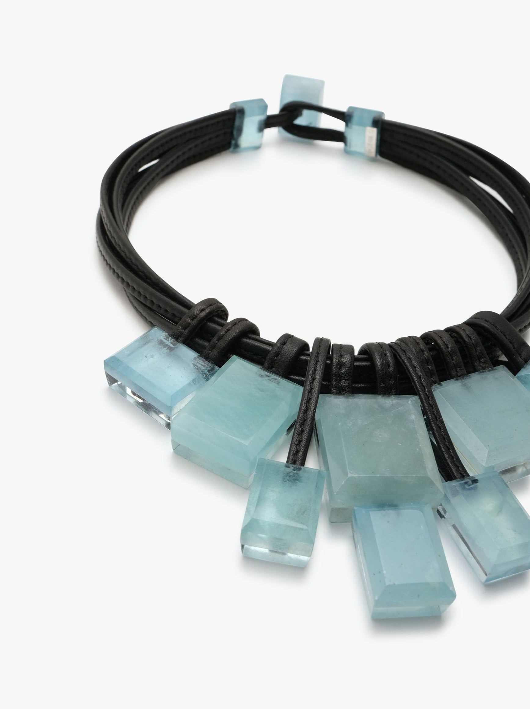 Aquamarine gemstone necklace with leather accents and a toggle clasp lock