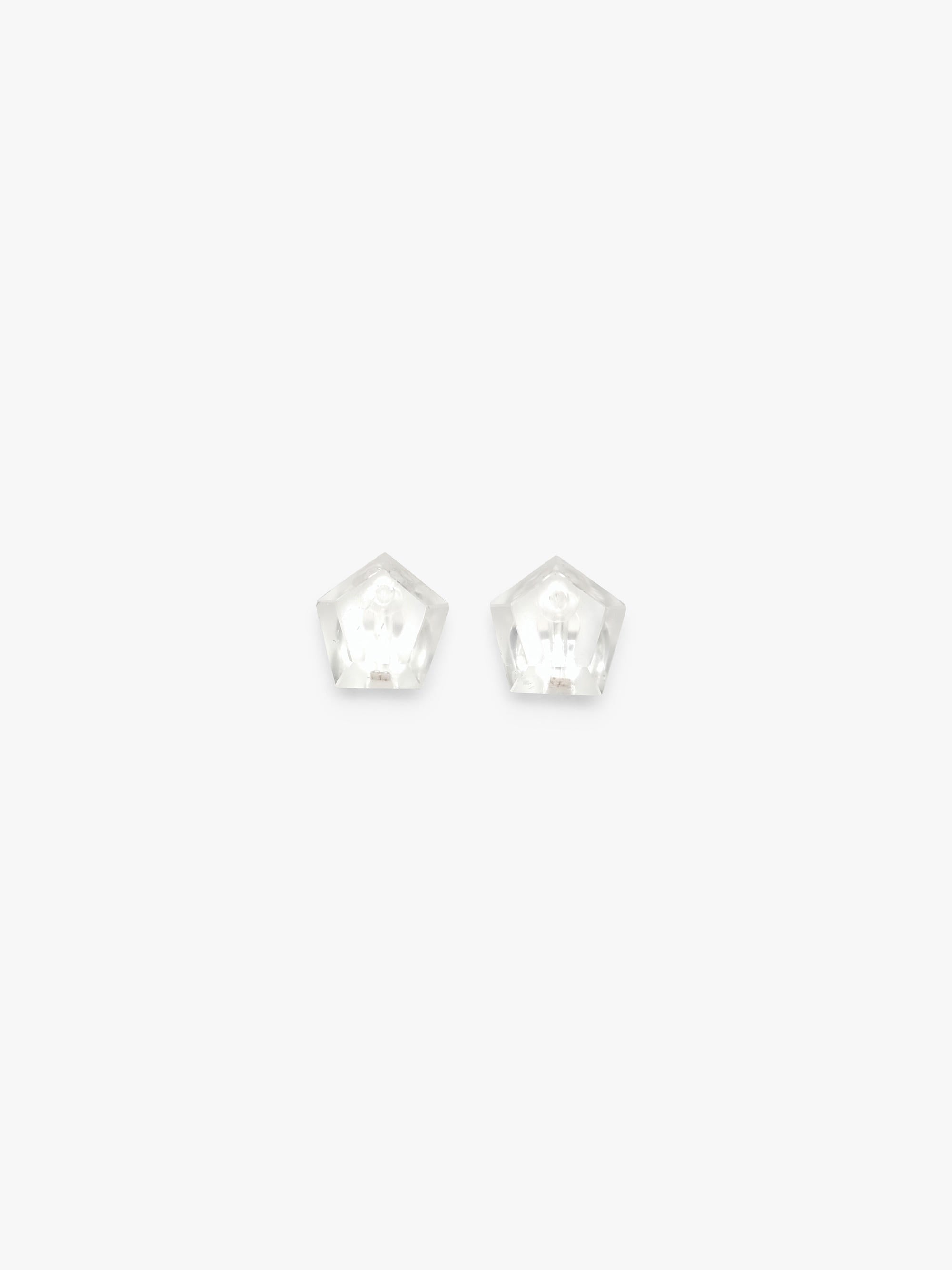 A pair of small, clear, pentagonal stud earrings on a solid white background.