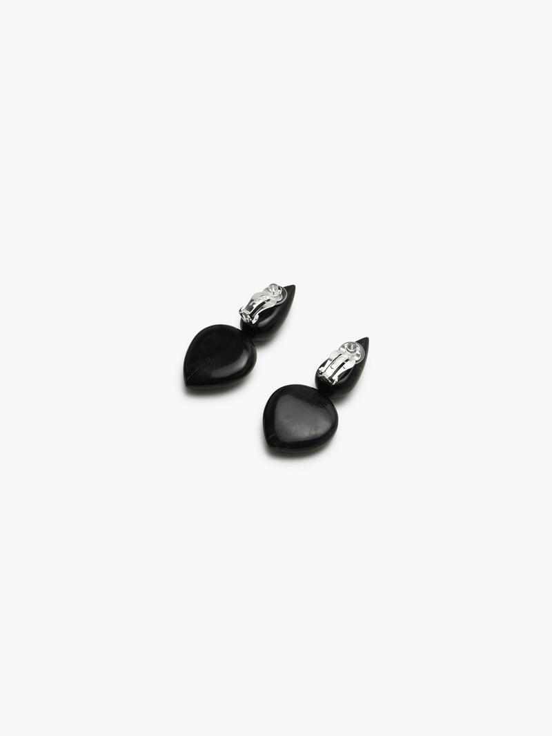 Pair of earrings with black and blue stones on a white background