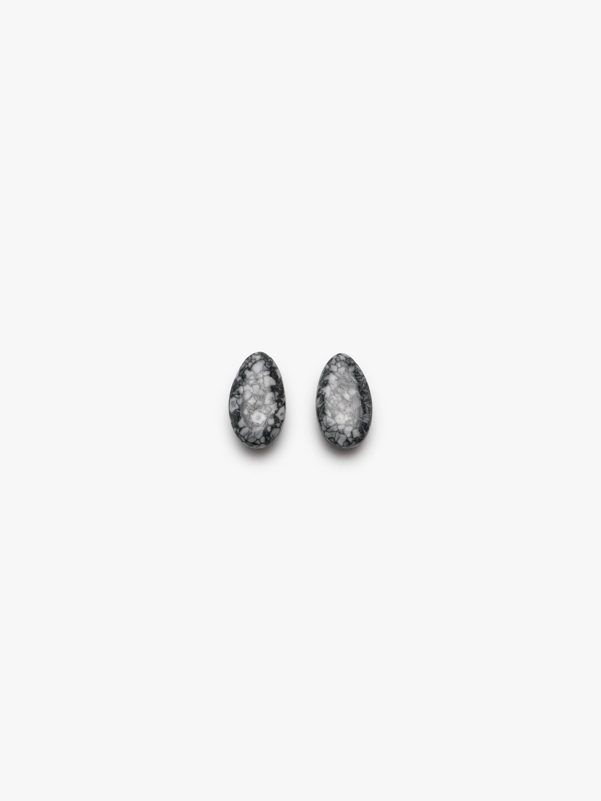 grey stone earring with grey, white and black accents on a white background