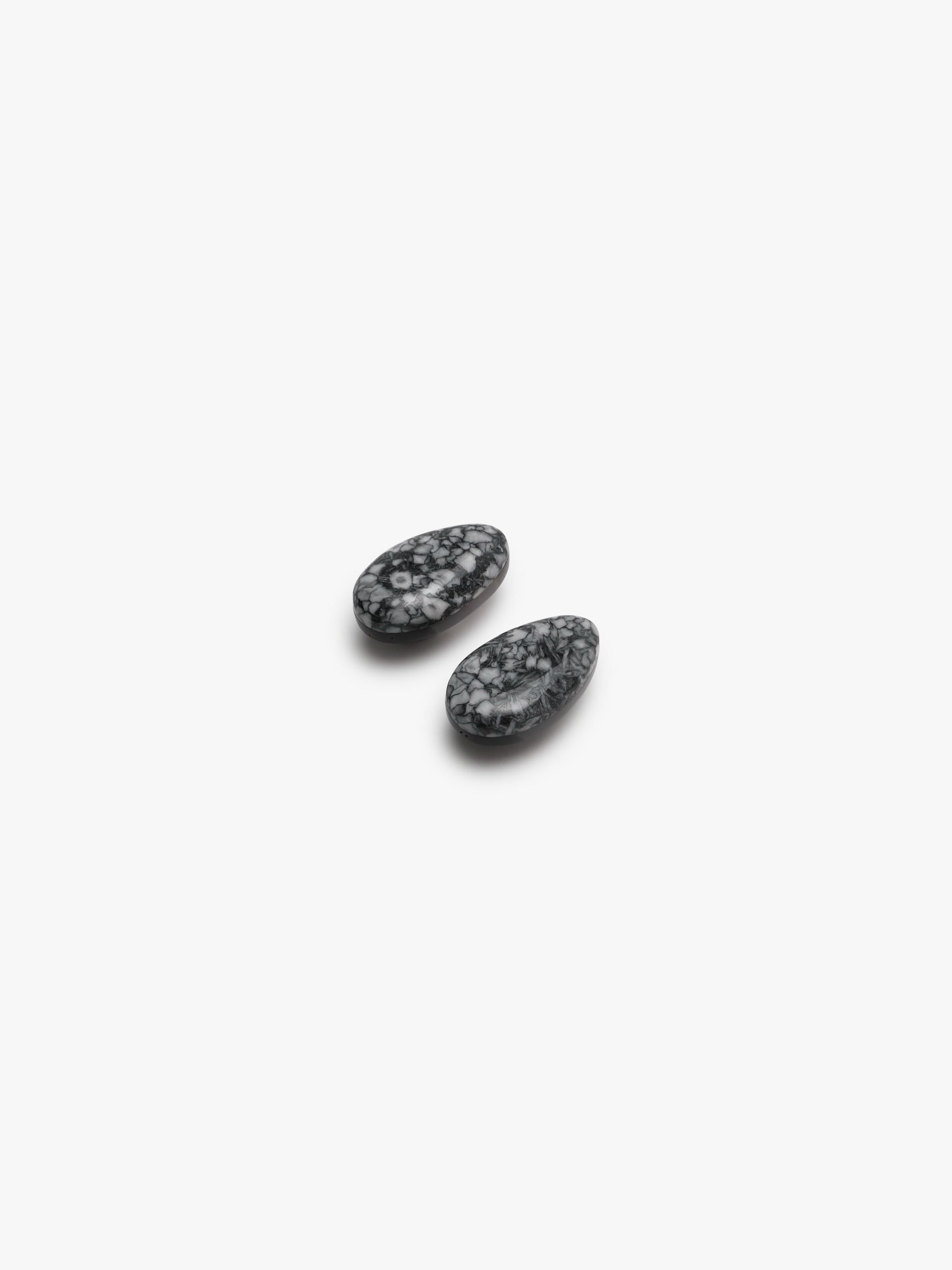 grey stone earring with grey, white and black accents on a white background