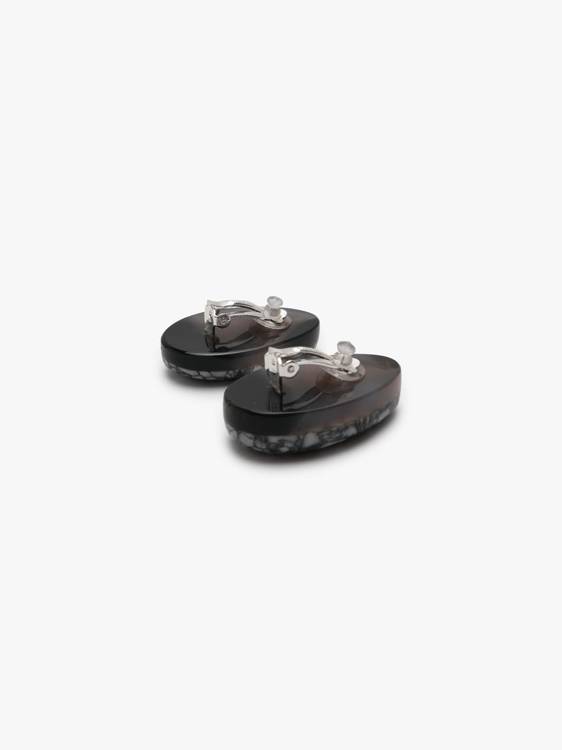 grey stone earring with grey, white and black accents on a white background