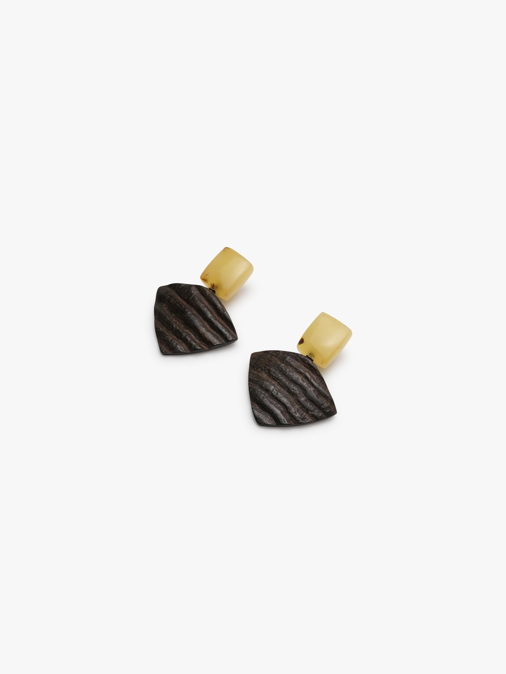 Geometrical earrings in yellow and brown on a white background