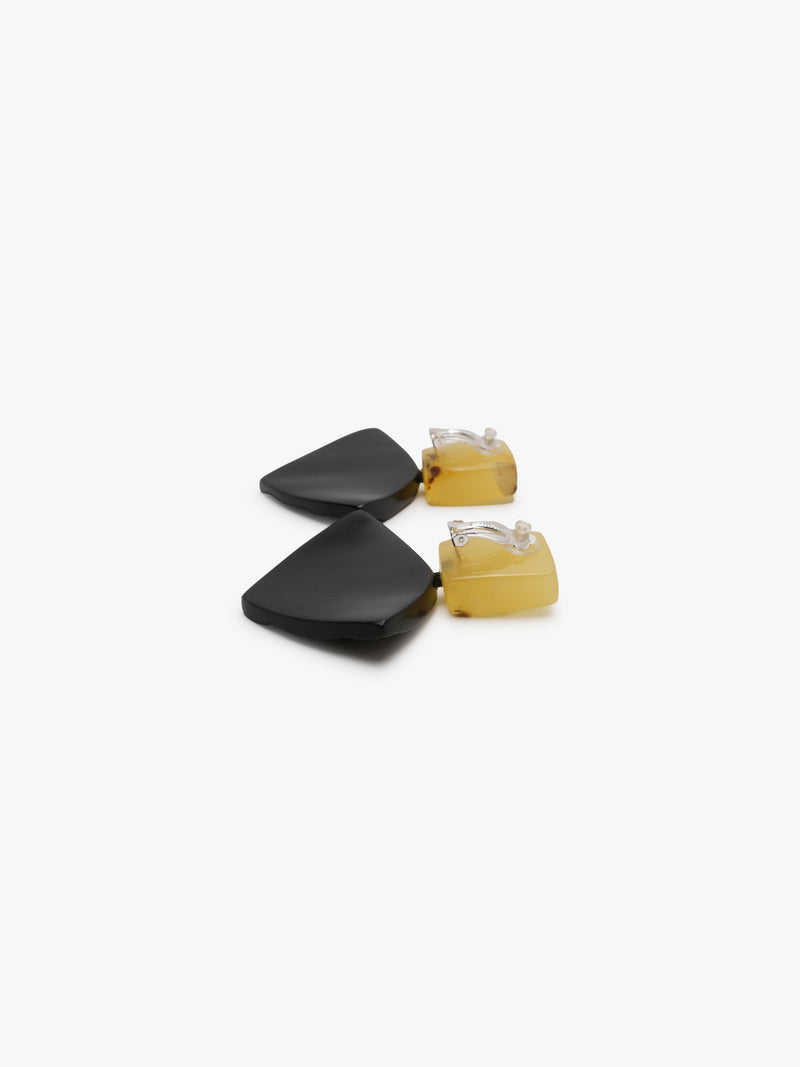 Geometrical earrings in yellow and brown on a white background