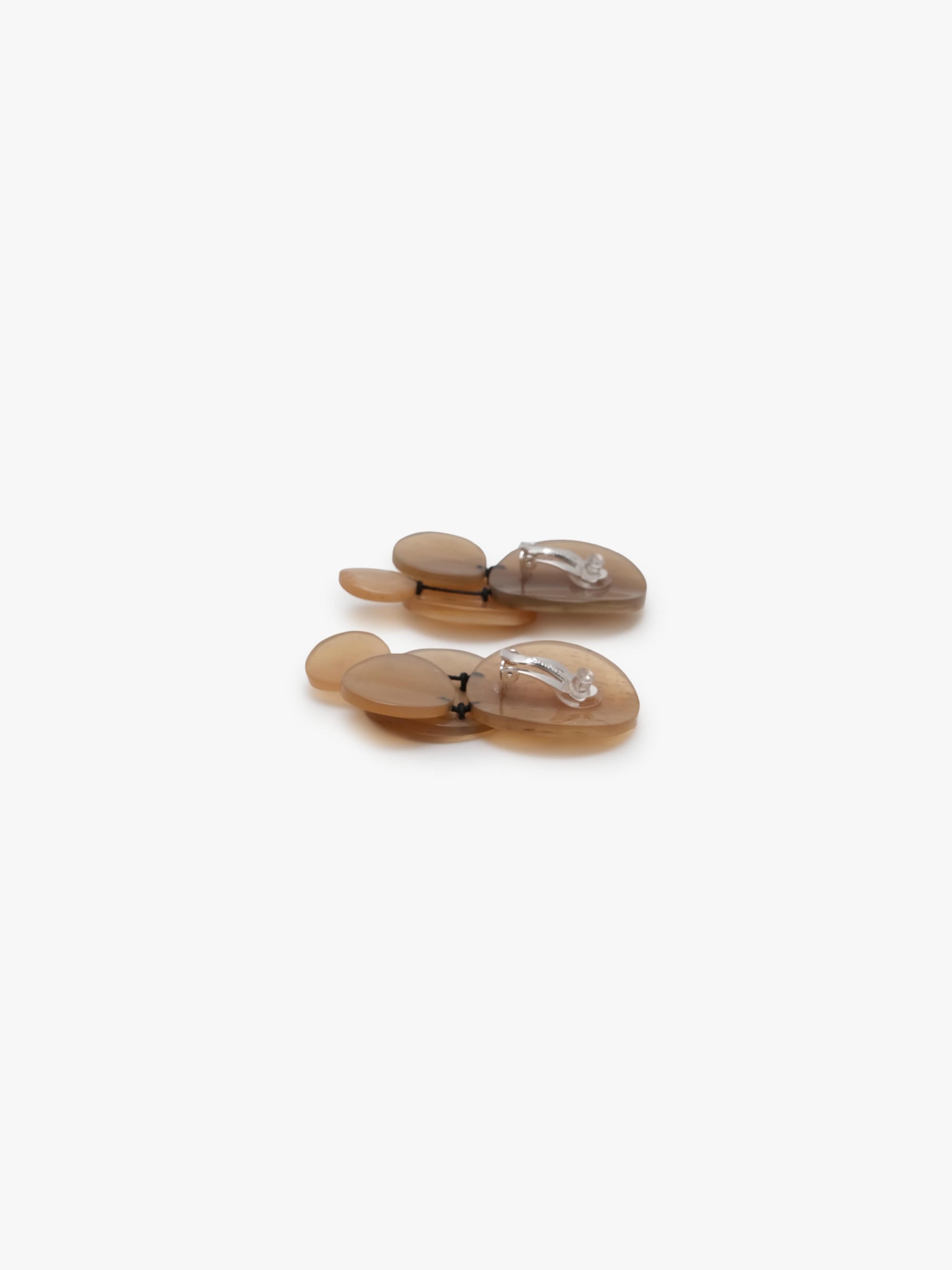 A pair of translucent brown earrings  displayed on a clean white background.