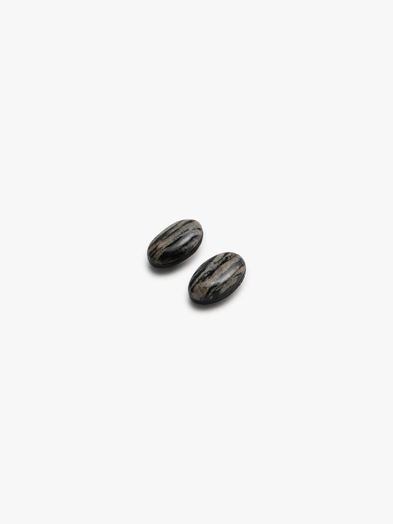 two striped earrings in natural stone on a white background