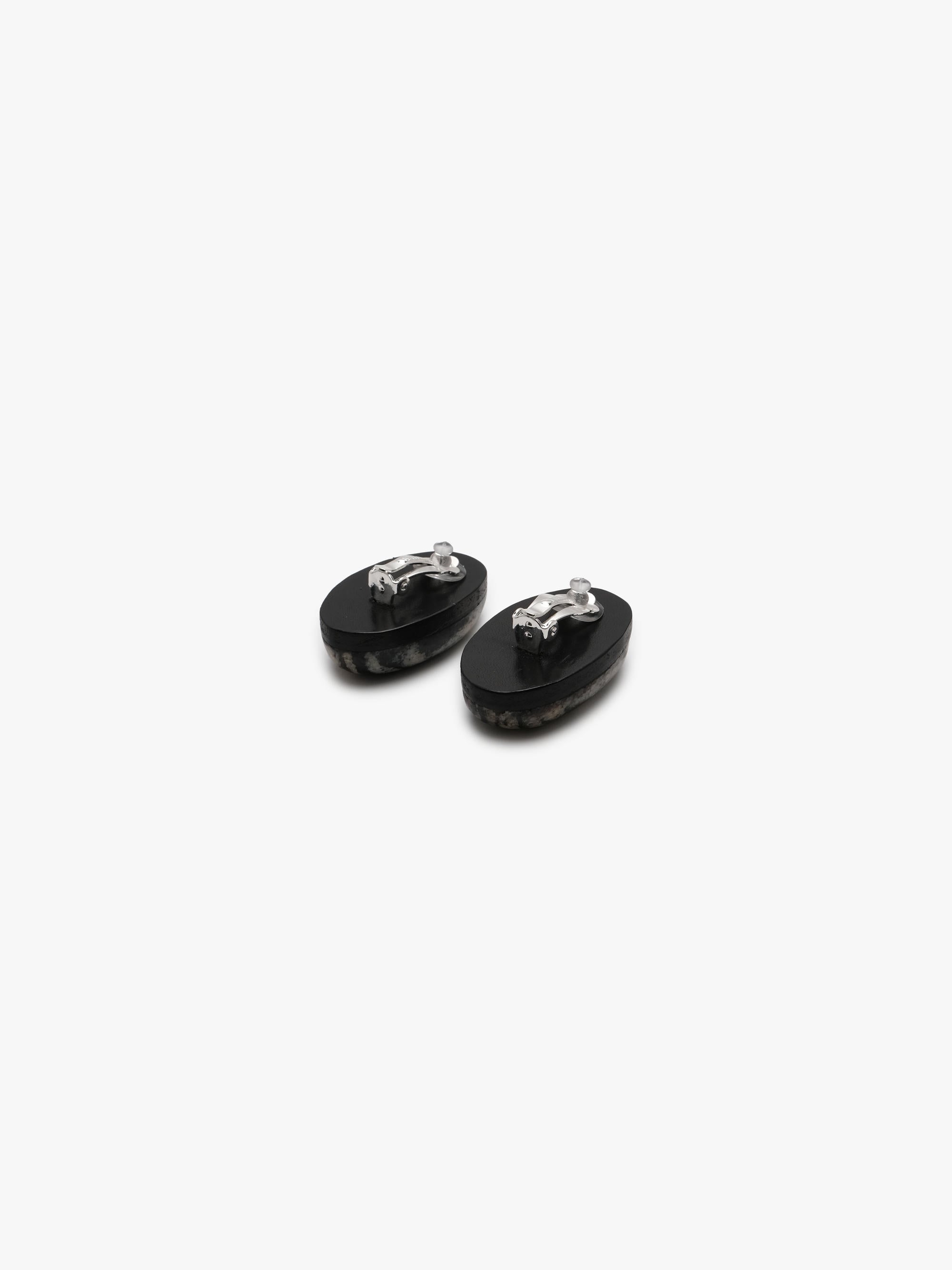 two striped earrings in natural stone on a white background