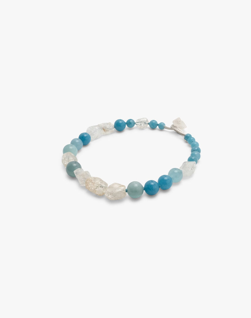 necklace made of blue and clear crystal beads displayed on a hite background
