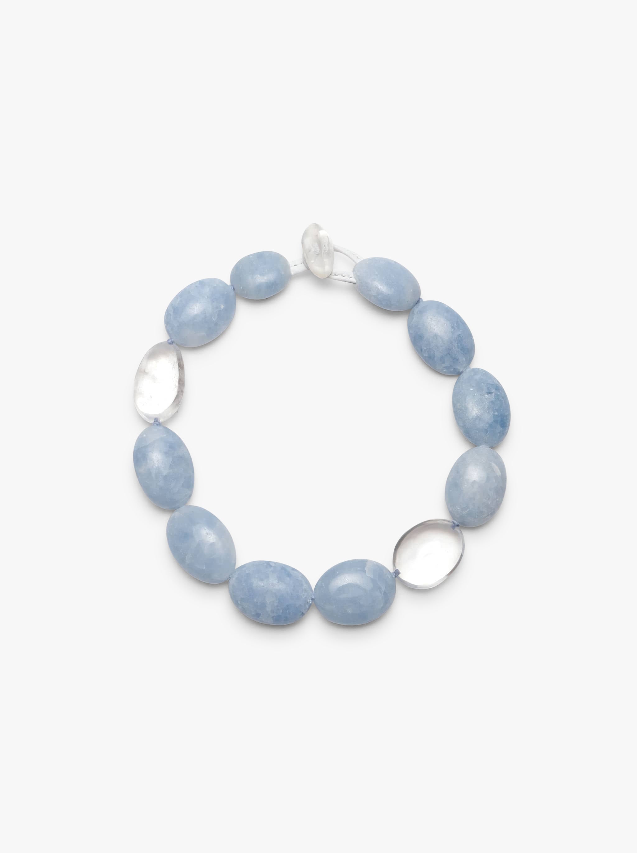 Necklace made of clear and blue beads displayed on a white background